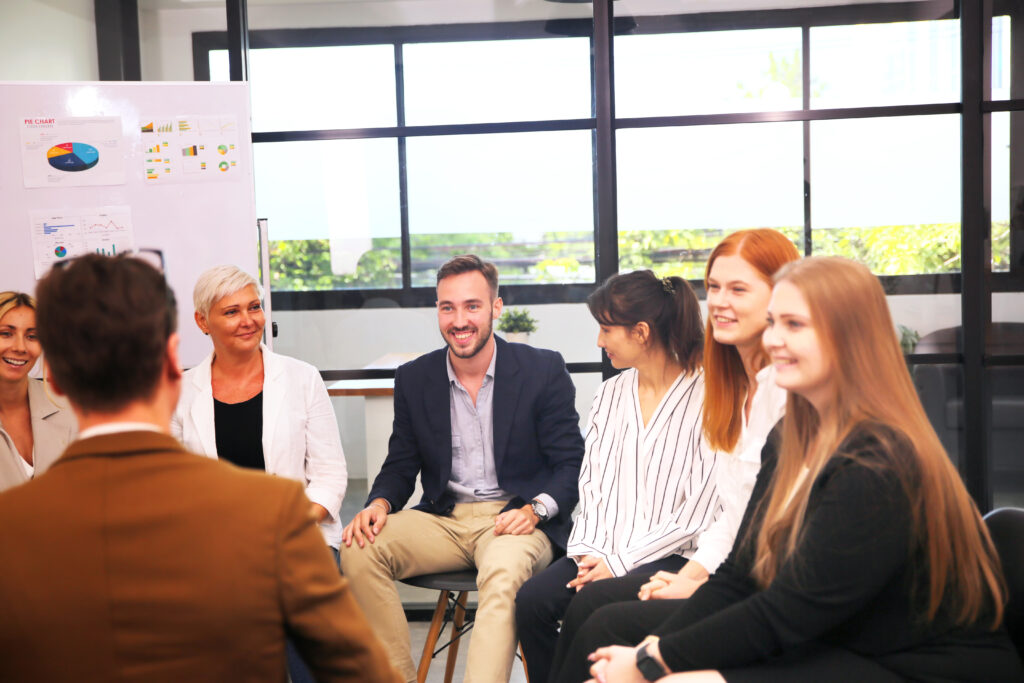 Shot of a mature businesswoman sitting and training her team in the office.
